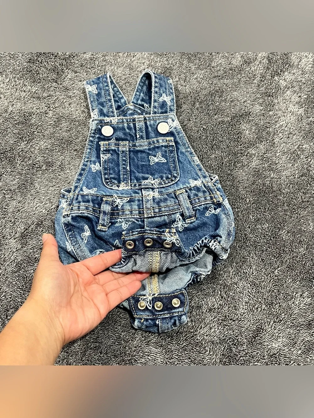 Old Navy jean romper for babies features an all-over white butterfly print 0-3